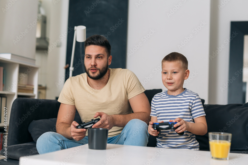 father and son playing video games at home father and son playing video games at home