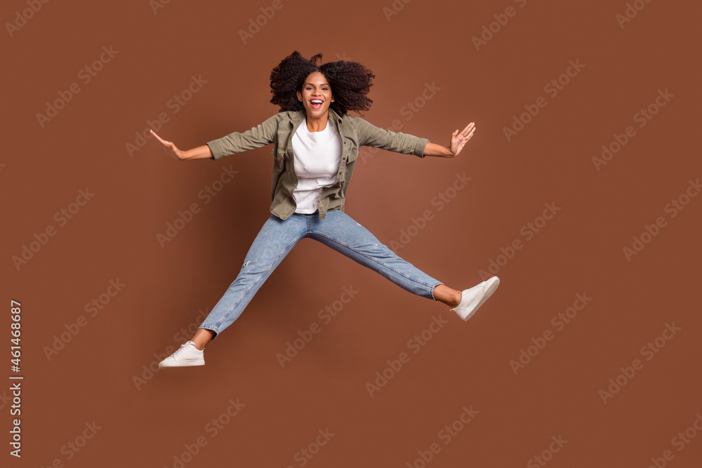 Full body portrait of overjoyed satisfied childish person toothy smile isolated on brown color background