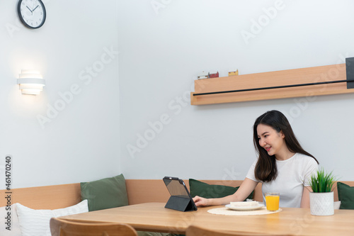 Living room concept a woman using her electronic device to work remotely in the cozy room of the coffee shop