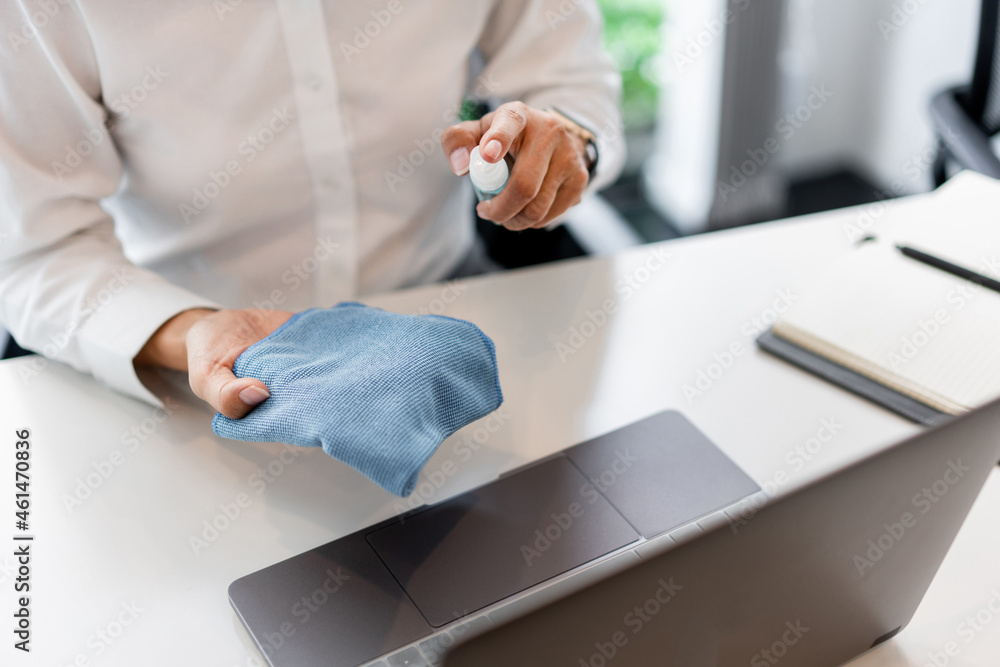 Fototapeta premium Sanitizing and cleaning the surfaces of devices before touching or using to avoid infectious virus