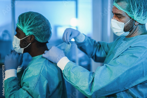 Medical doctors at work inside hospital during coronavirus outbreak - Focus on right man face