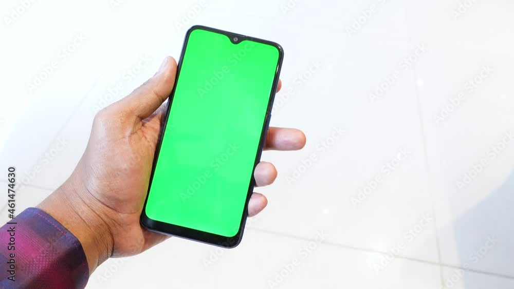 Close up of young man hand using smart phone with green screen Close up of young man hand using smart phone with green screen