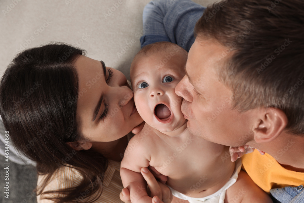 Happy family with their cute baby indoors, above view Happy family with their cute baby indoors, above view