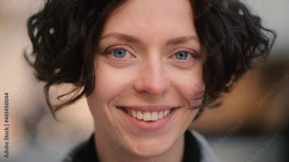 Portrait of young beautiful caucasian woman looking at the camera at the sunset. Close up of happy young girl smiling. High quality 4k footage Portrait of young beautiful caucasian woman looking at the camera at the sunset. Close up of happy young girl smiling. High quality 4k footage