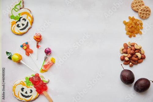 Trick or treat concept lettering. Healthy and unhealthy food in comparison  Alternative to sweets and candies - nuts  fruits and dried fruits. Copy space