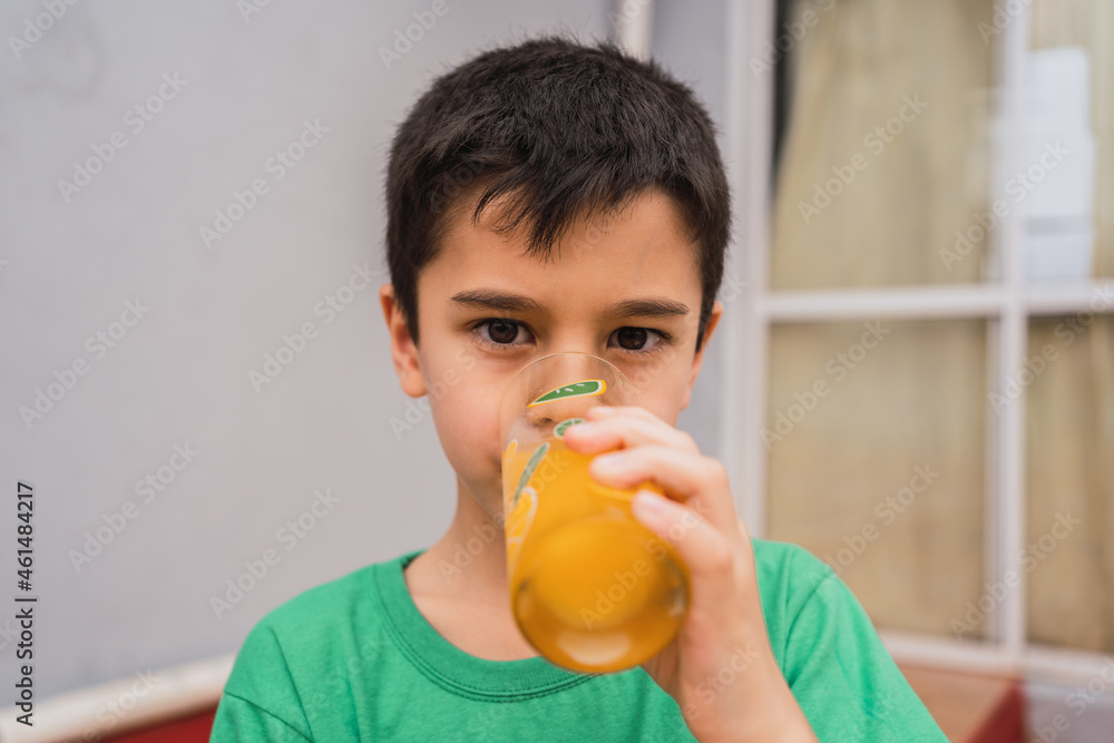 Boy drinking juice from glass Boy drinking juice from glass