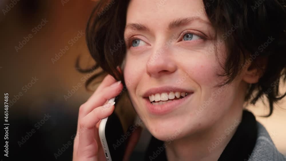 Portrait of attractive girl having phone talk. Young beautiful girl walking down the street. Happy smiling girl walking forward. High quality 4k footage Portrait of attractive girl having phone talk. Young beautiful girl walking down the street. Happy smiling girl walking forward. High quality 4k footage
