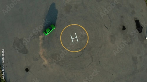 Ariel overhead shot drift sports car in a circle. Ariel overhead shot drift sports car in a circle. Helipad