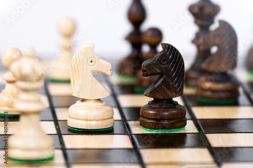 Two chess knight compete with each other  Chessboard Background  Take a strategy. Game of Chess. Game to Development Analysis Strategy Plan  Leader and Teamwork Concept for Success.Success Strategy.