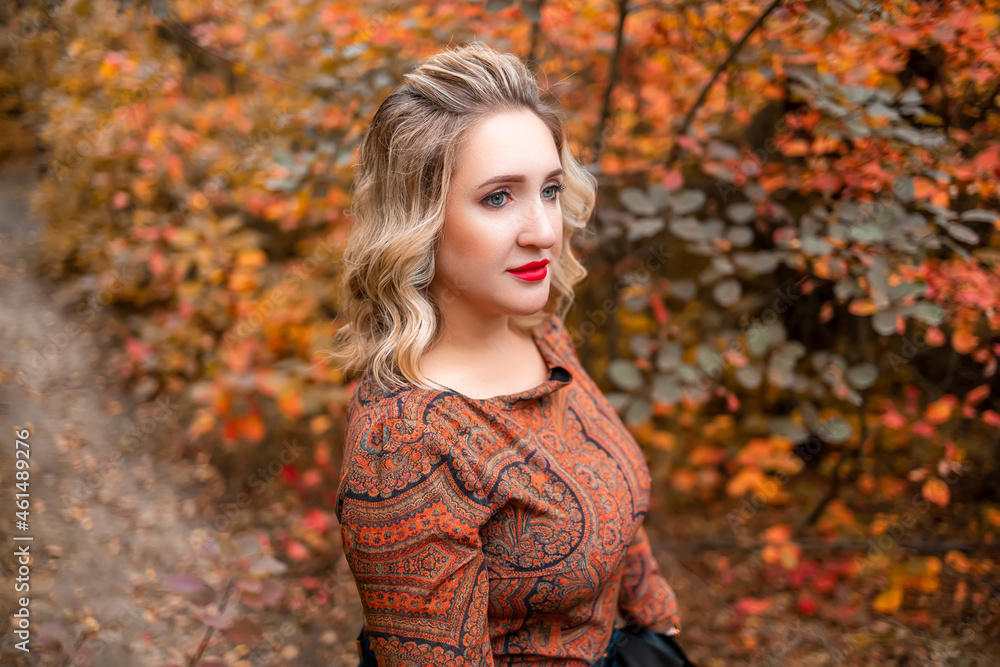 a young woman on the background of an autumn park a young woman on the background of an autumn park