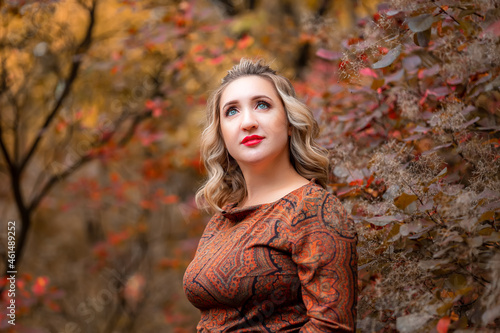 a young woman on the background of an autumn park