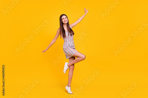 Full length body size confident girl in dress smiling overjoyed careless isolated vivid yellow color background
