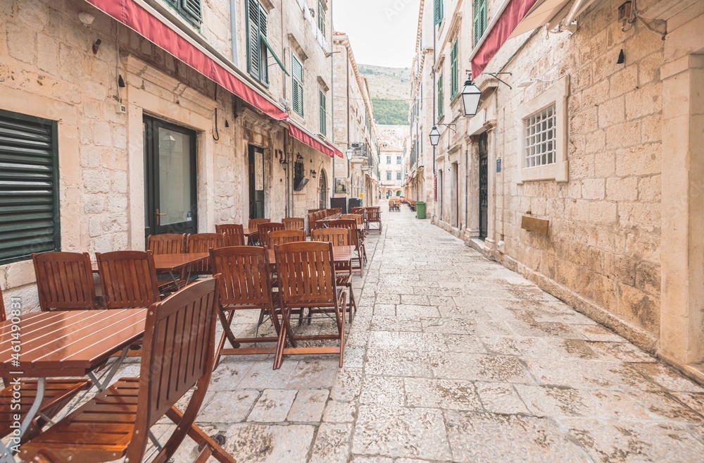 Fototapeta premium Travel to Croatia. Dubrovnik old town and harbor with narrow stone stairway leads to the old town in Dubrovnik, Croatia, with its well-preserved stone walls that seem to touch the clear blue sky