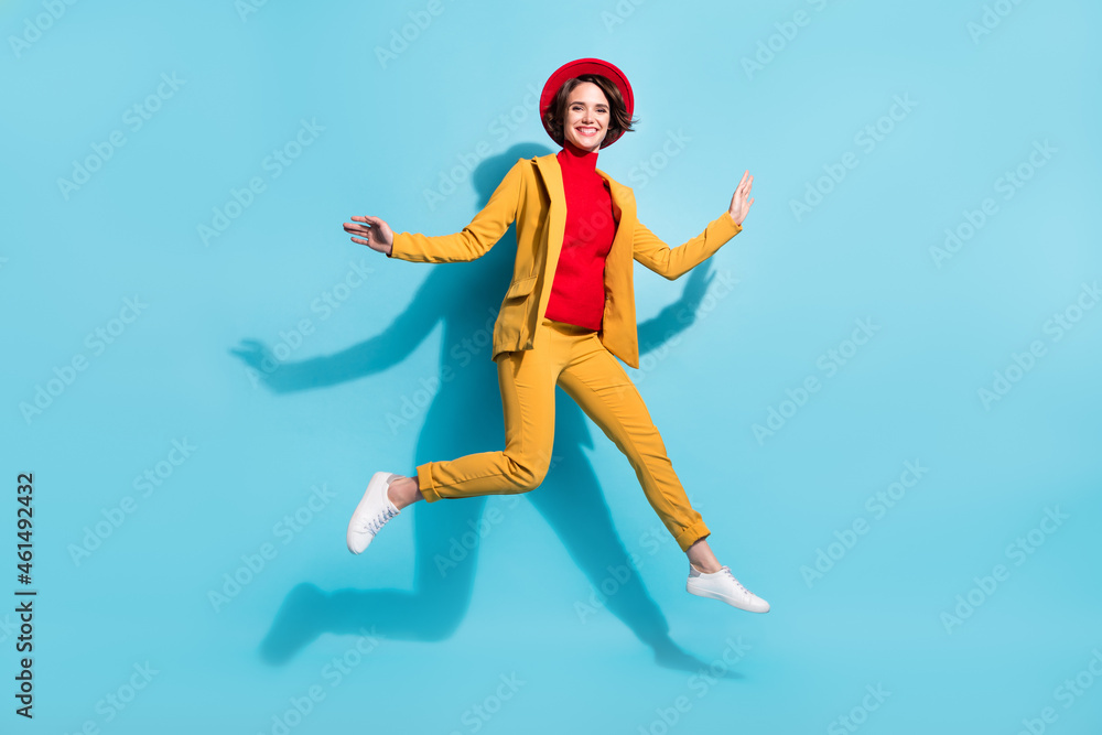 Full length body size view of attractive cheerful pretty girl jumping having fun isolated over bright blue color background