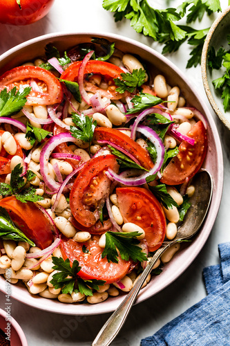 A piyaz salad, a traditional Turkish White Bean Salad PIyaz. Served in a ceramic bowl. photo