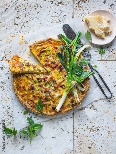 Quiche Lorraine served with parmessan cheese photo