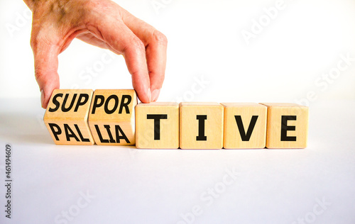 Palliative or supportive therapy symbol. Doctor turns cubes, changes words palliative to supportive. Beautiful white background, copy space. Medical, palliative or supportive therapy concept.