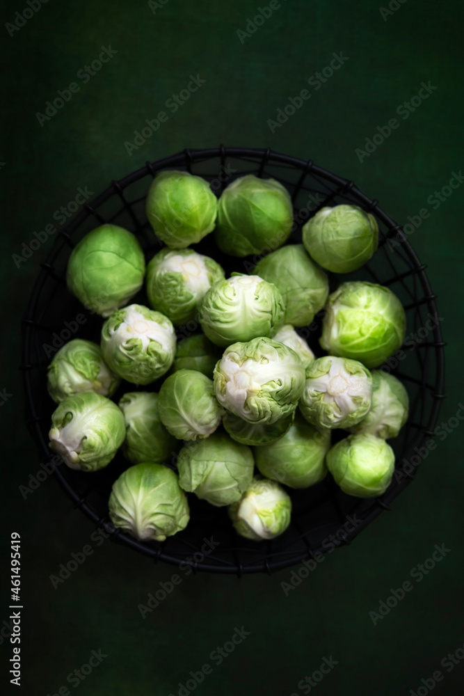 Raw brussel sprouts on a dark green background. Raw brussel sprouts on a dark green background.