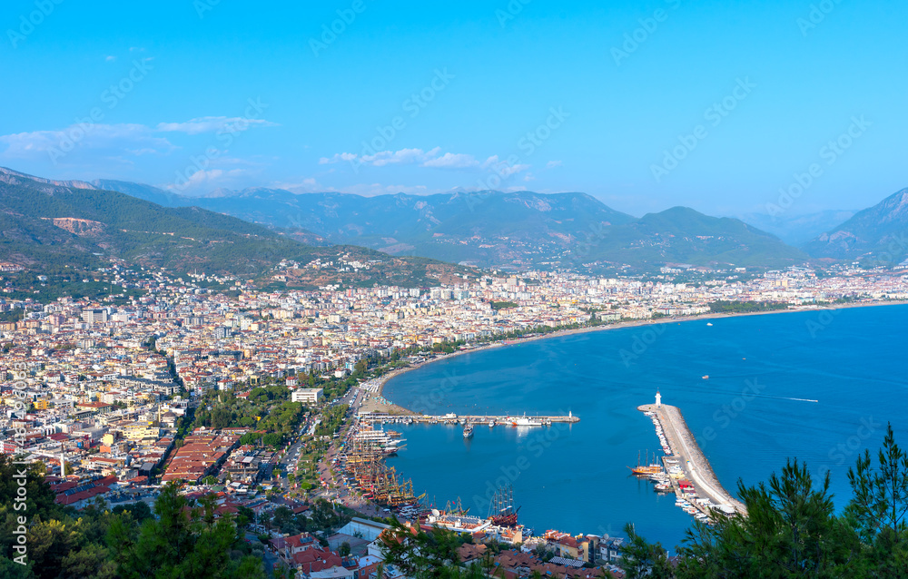 Aerial view of the port with ships and a lighthouse in the city of Alanya