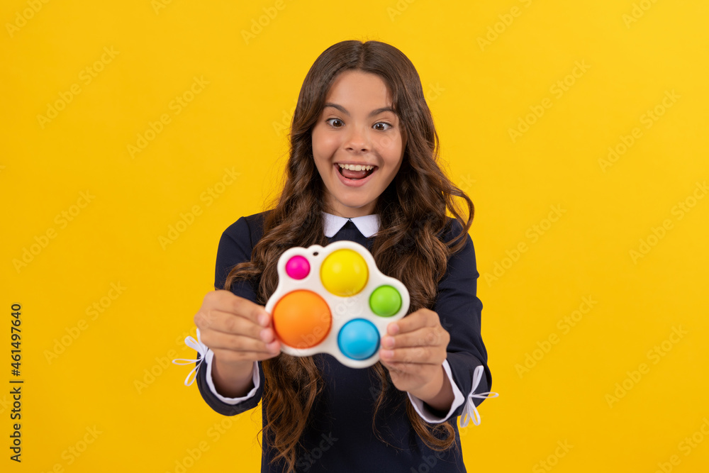 amazed child showing simple dimple popit fidget. antistress silicone toy. sensory fidgeting. amazed child showing simple dimple popit fidget. antistress silicone toy. sensory fidgeting.