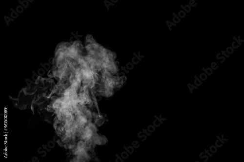 Fragment of white hot curly steam smoke isolated on a black background. Create mystical Halloween photos