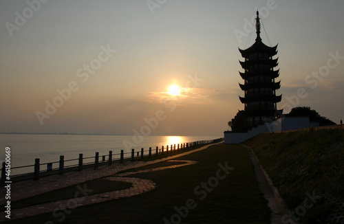 Park used as a viewing site for the tidal bore on the estuary of the Qiantang River. Northern bank of the Qiantang River near Hangzhou in Zhejiang Province  China. Sunset view with pagoda