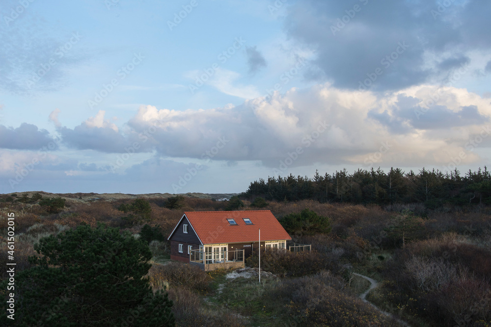vacation house in the dunes of the Wadden isle Vlieland at the end of a sunny day in autumn vacation house in the dunes of the Wadden isle Vlieland at the end of a sunny day in autumn