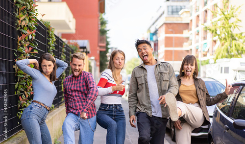 Canvastavla Multiethnic friends walking at sidewalk acting foolish funny moves - Happy guys