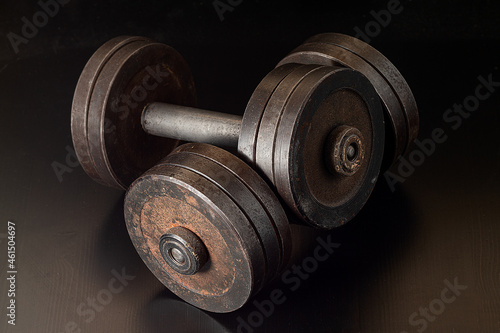 rusty dumbbell. gym fitness concept dumbbell on dark background