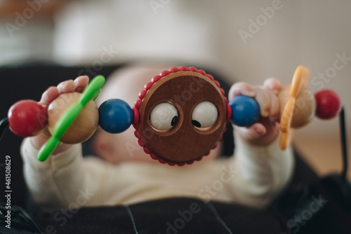 baby playing with wooden beads photo
