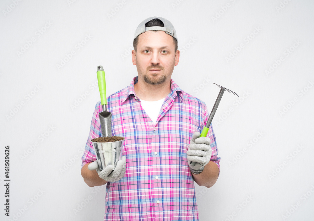 Portrait of male gardener with gardening tools, isolated on white background. Male farmer Portrait of male gardener with gardening tools, isolated on white background. Male farmer