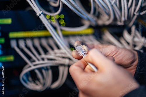 Technician holding ethernet cable. Setting up the connection. photo