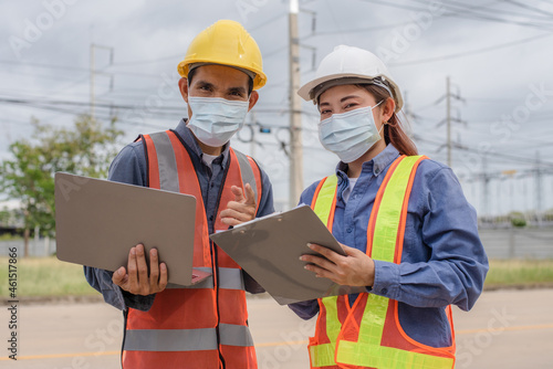 Two engineer wear face mask in work site outdoor protect coronavirus covid19, engineer teamwork