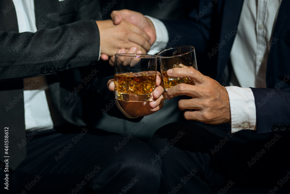 Businessmen in suits drinking whiskey Businessmen in suits drinking whiskey