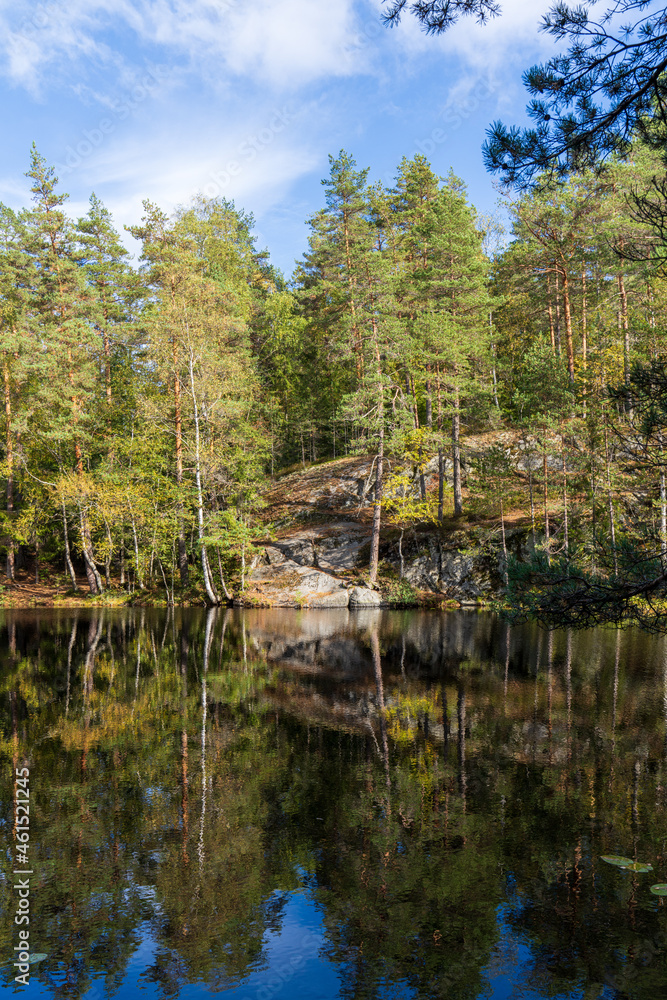 The small Skøyenputten lake in Østmarka near Oslo, early fall The small Skøyenputten lake in Østmarka near Oslo, early fall