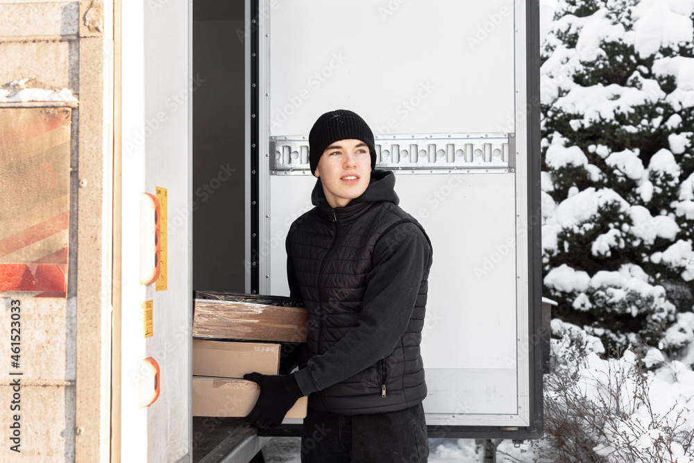 Man unloading parcels from car trunk Man unloading parcels from car trunk