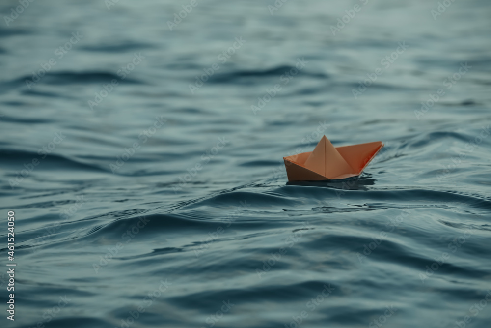 Paper boat floating on water outdoors. Space for text
