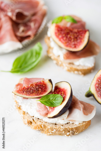 Bruschetta with ricotta, figs and prosciutto. Healthy italian appetizer toast