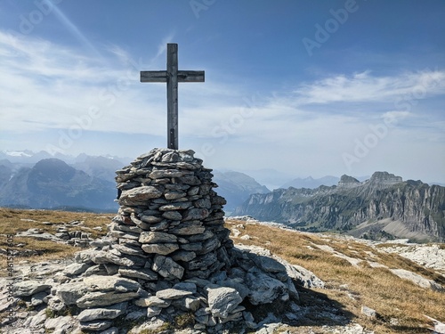 Summit cross on the Silberen mountain in the canton of Uri above the Pragelpass. Beautiful hiking and ski touring region photo