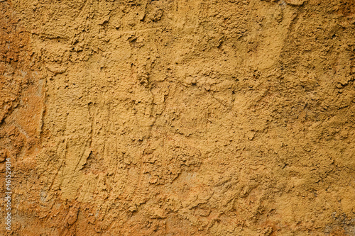 Ochre colored cement plaster wall texture