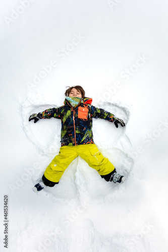 boy doing a snow angel