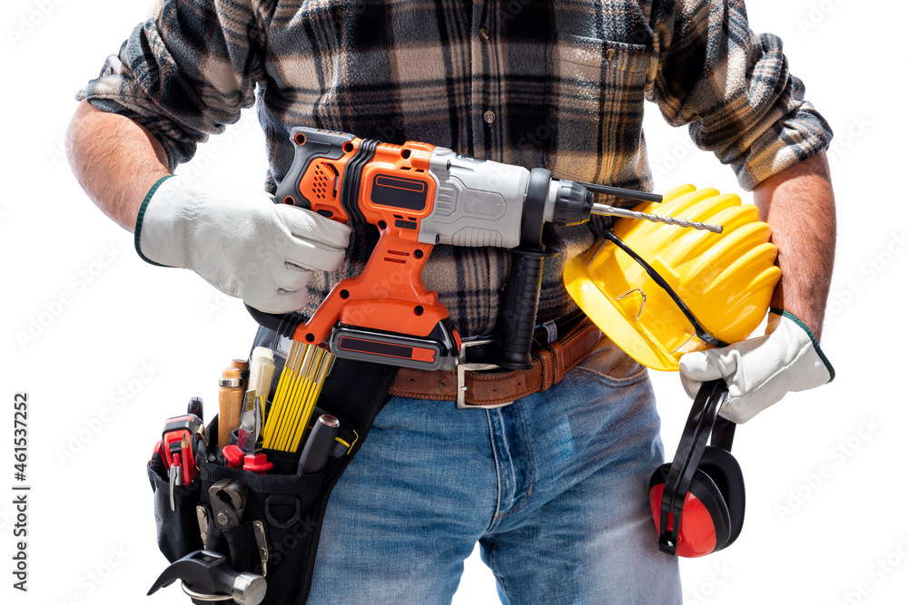 Carpenter holding rechargeable hammer drill, isolated on white background. Work safety. Carpenter holding rechargeable hammer drill, isolated on white background. Work safety.