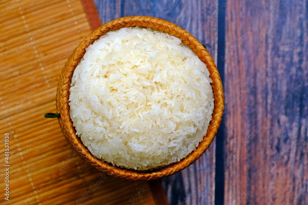 Sticky rice in bamboo wicker basket on wooden table. Sticky rice in bamboo wicker basket on wooden table.