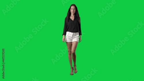 Luxury well-dressed runway fashion model walking in slow motion. Full body on green screen chroma key background