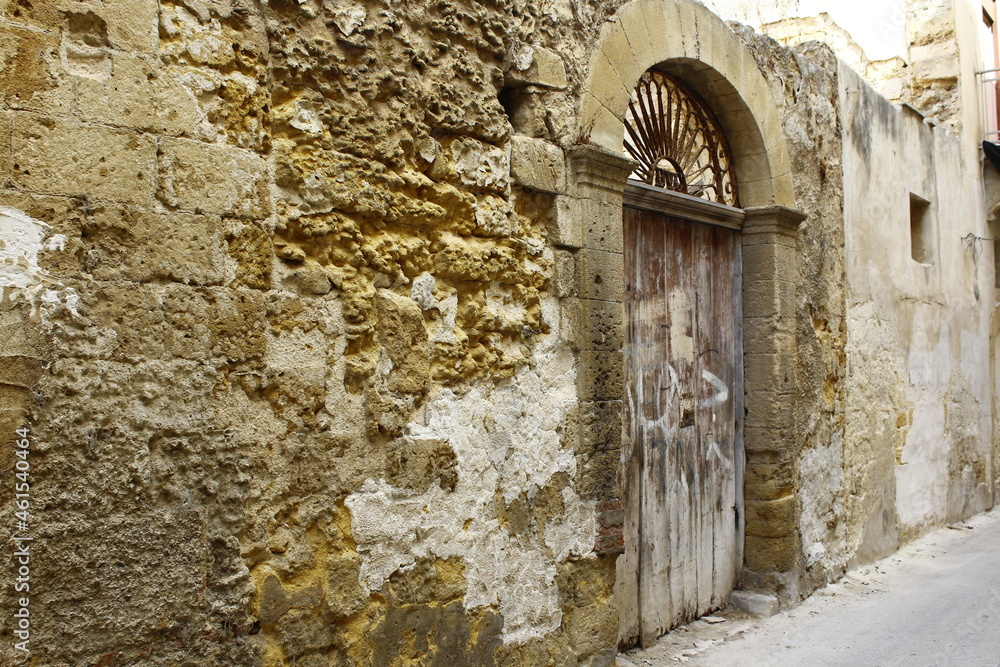 Mazara del Vallo old narrow street and wooden door, Trapani, Sicily, Italy