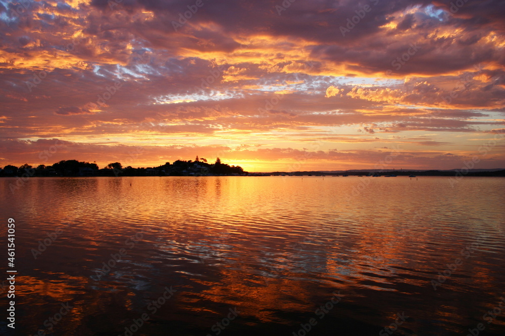 Naklejka premium sunset over the river