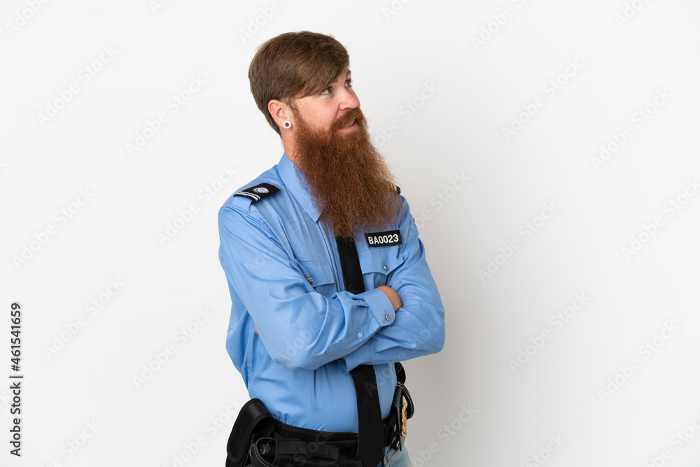 Redhead police man isolated on white background with arms crossed and happy Redhead police man isolated on white background with arms crossed and happy