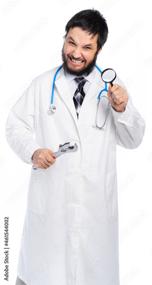 a medic in a white coat holds an adjustable wrench and a magnifying glass. the doctor grins, is determined to decide. scary dentist. isolated, white background a medic in a white coat holds an adjustable wrench and a magnifying glass. the doctor grins, is determined to decide. scary dentist. isolated, white background