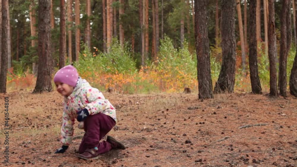 Little girl plays frisbee in autumn. Drops after throwing the cymbal. Little girl plays frisbee in autumn. Drops after throwing the cymbal.
