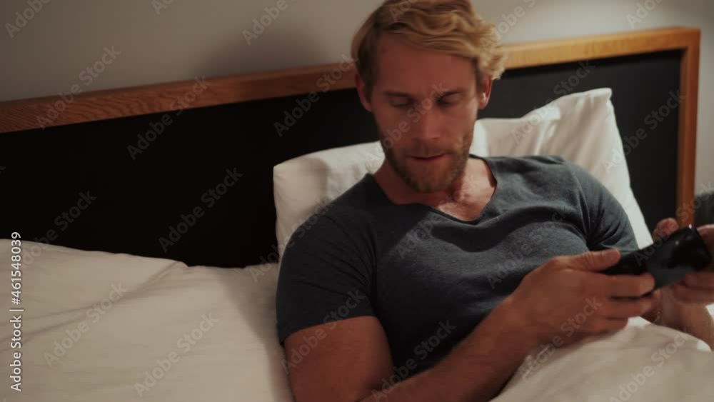 Close-up view of the tired man after watching the video, turn off the phone and go to bed Close-up view of the tired man after watching the video, turn off the phone and go to bed